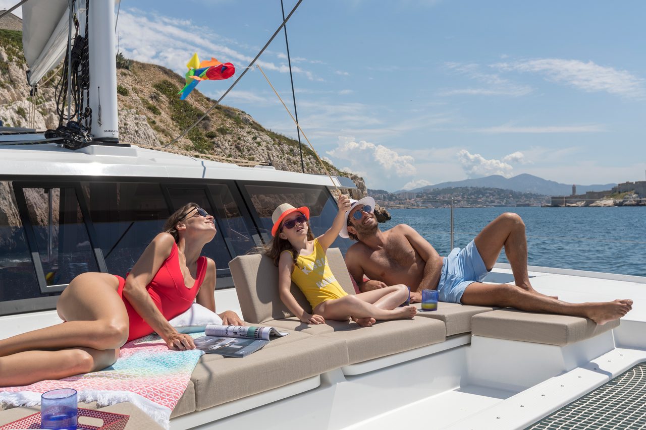 Anchored Astrea 42 with people lounging on deck