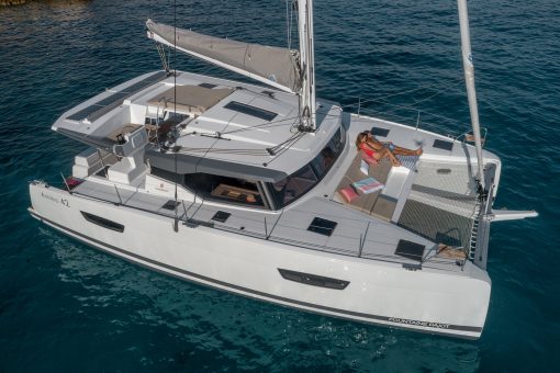 Couple on sunbed lounge of Fountaine Pajot Astrea 42 catamaran