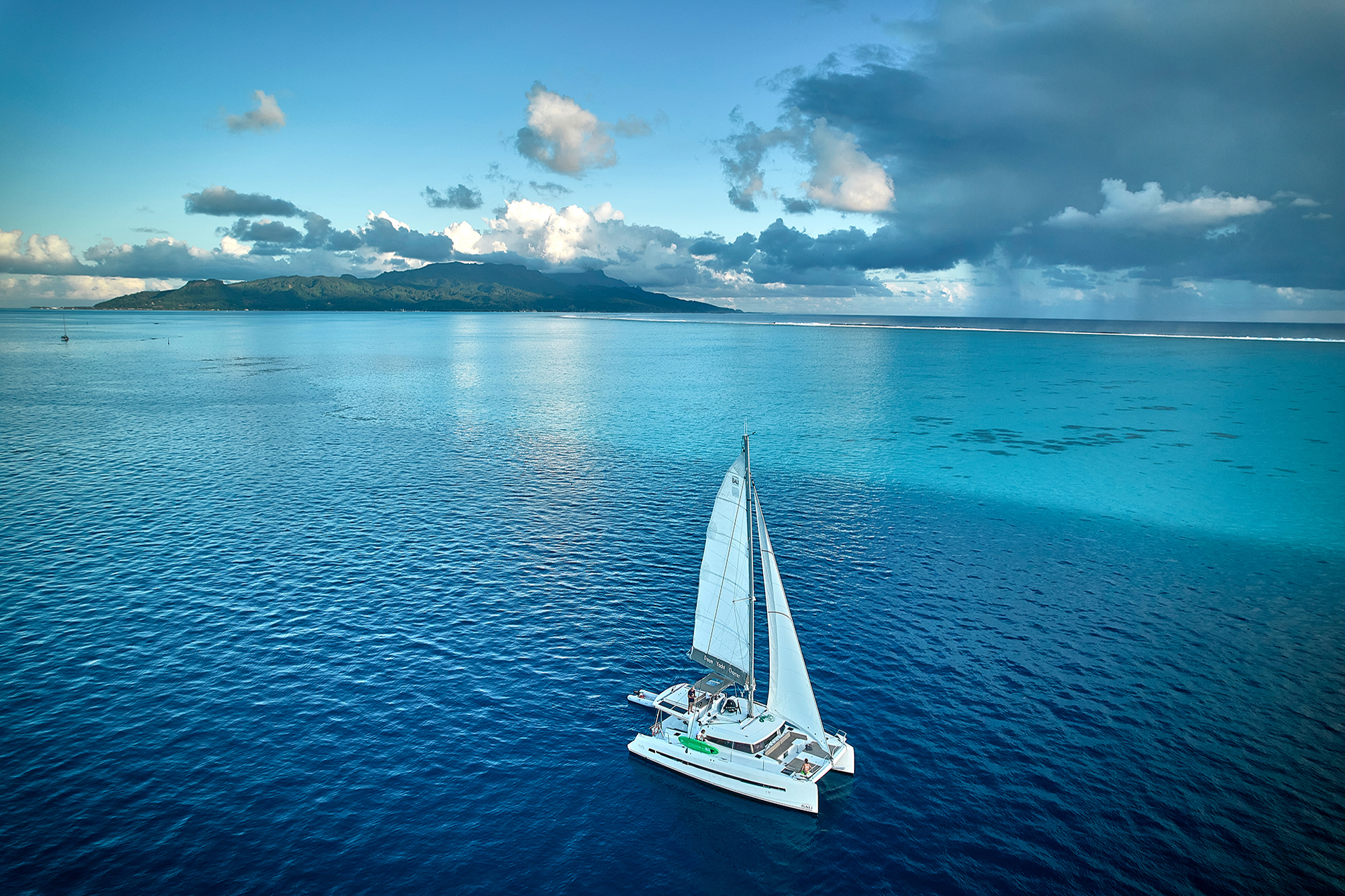 Woman on side deck of yacht in partnership ownership program enjoying view