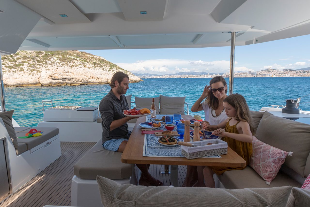 Family dining on deck of Fountaine Pajot Astrea 42 yacht