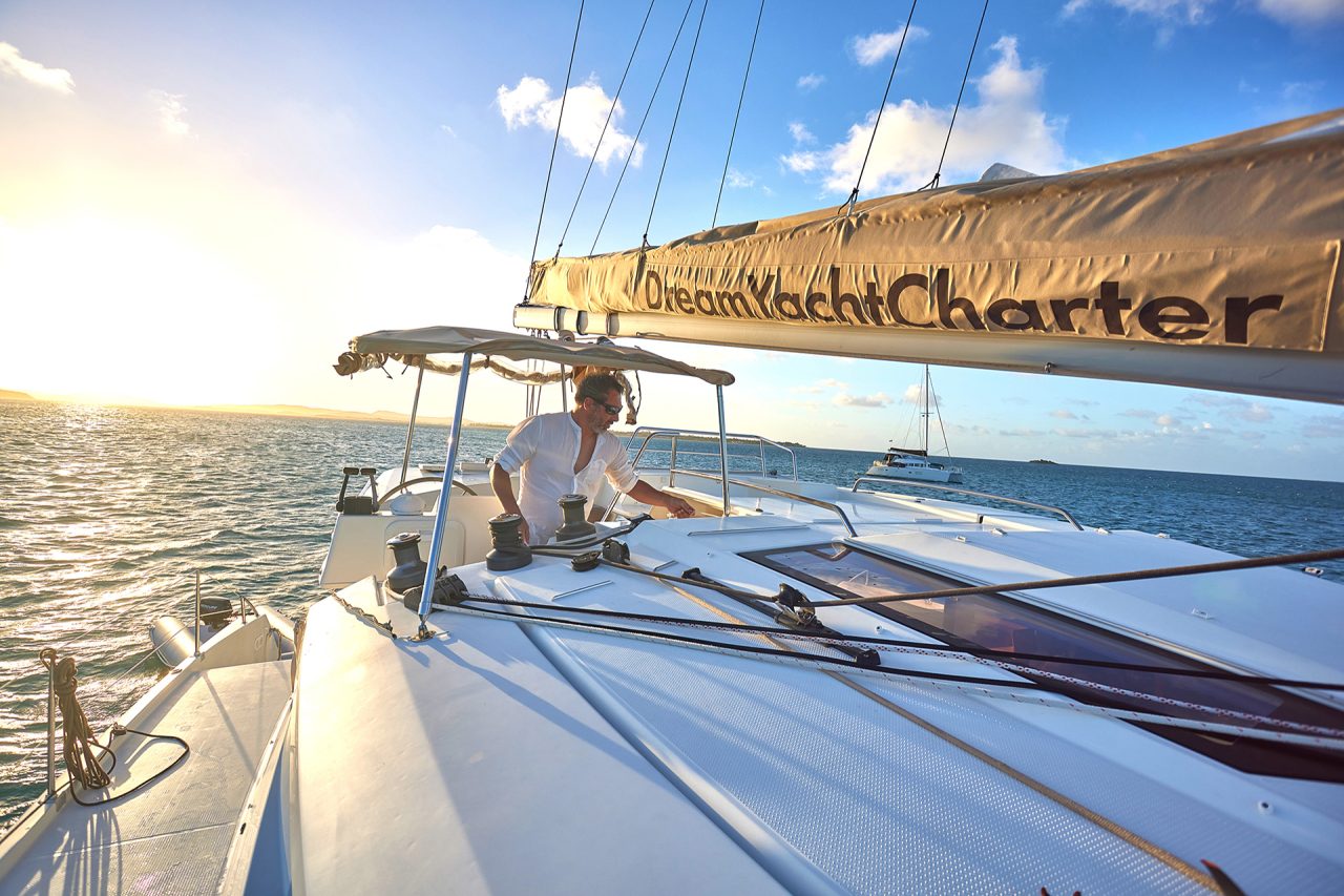 Man at helm of yacht in the Dream Performance yacht ownership program