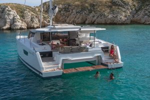 Fountaine Pajot Astrea 42 yacht at anchor with family enjoying the water