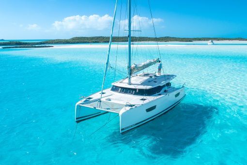 Dream Yacht catamaran anchored in clear blue shalllow water