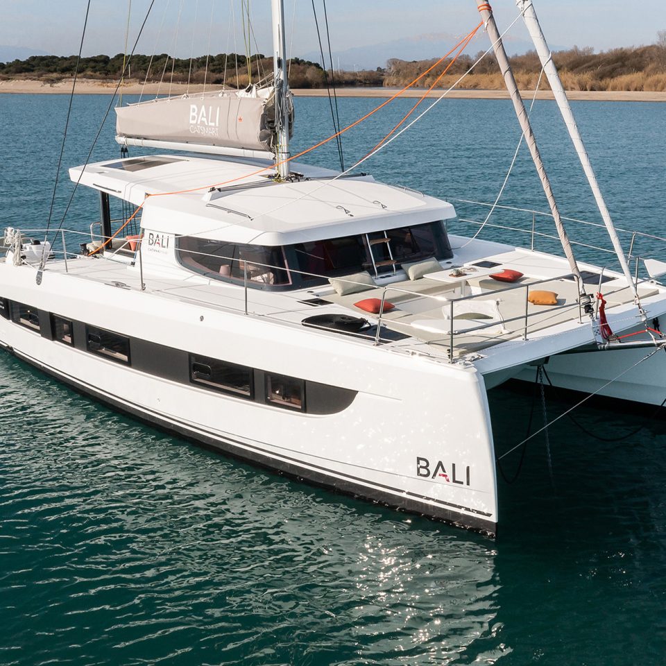 Bali Catsmart at anchor just of sandy shore