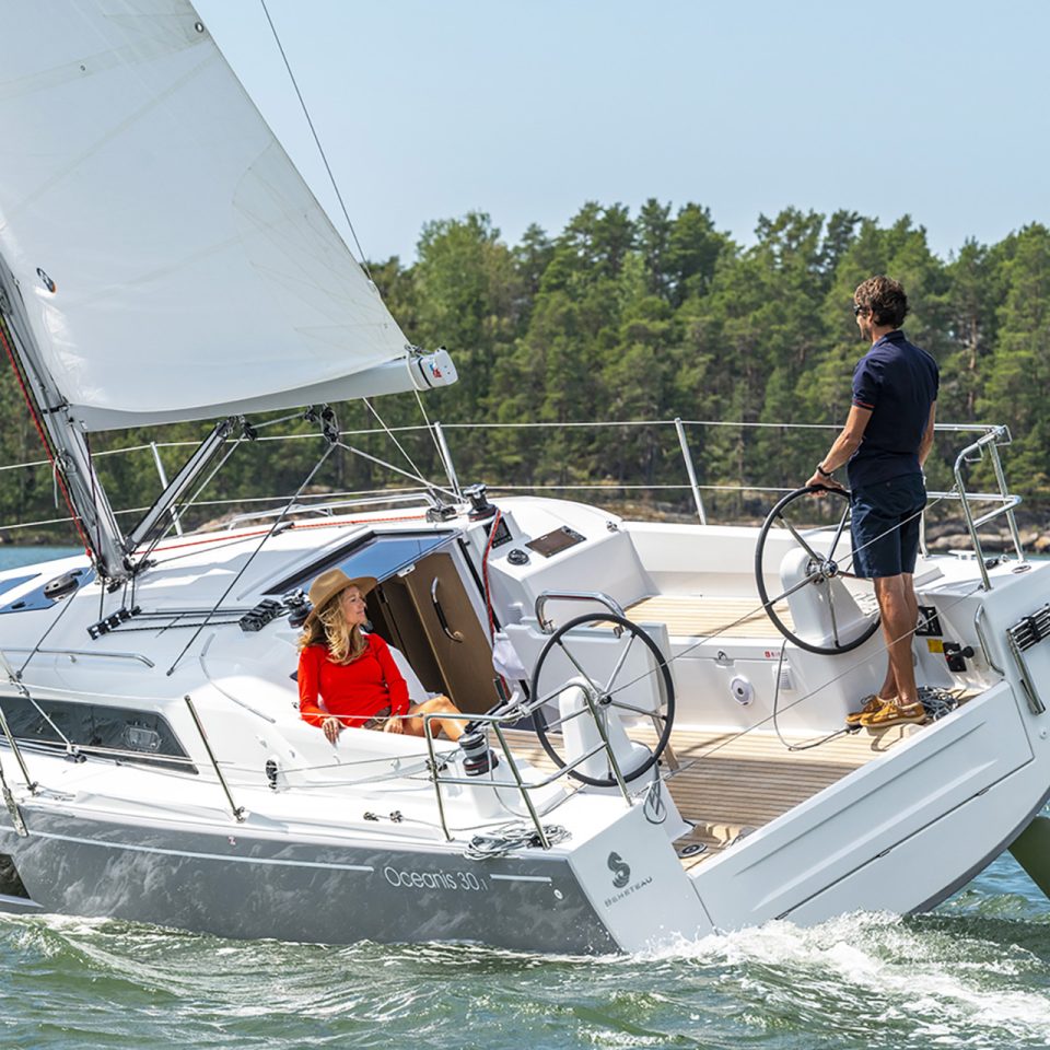 Beneteau 30.1 sailboat under brisk sail with man at helm