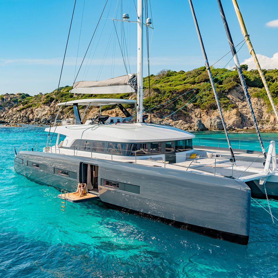 Lagoon seventy 7 luxury sailing catamaran at anchor near shore