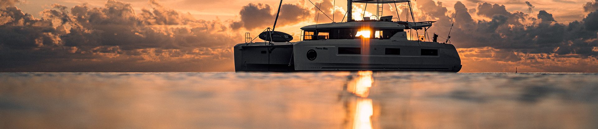 Sillouette of Dream Yacht catamaran anchored at dusk