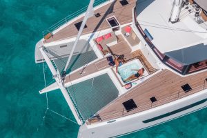 People lounging on front deck of the Alegria 67 catamaran