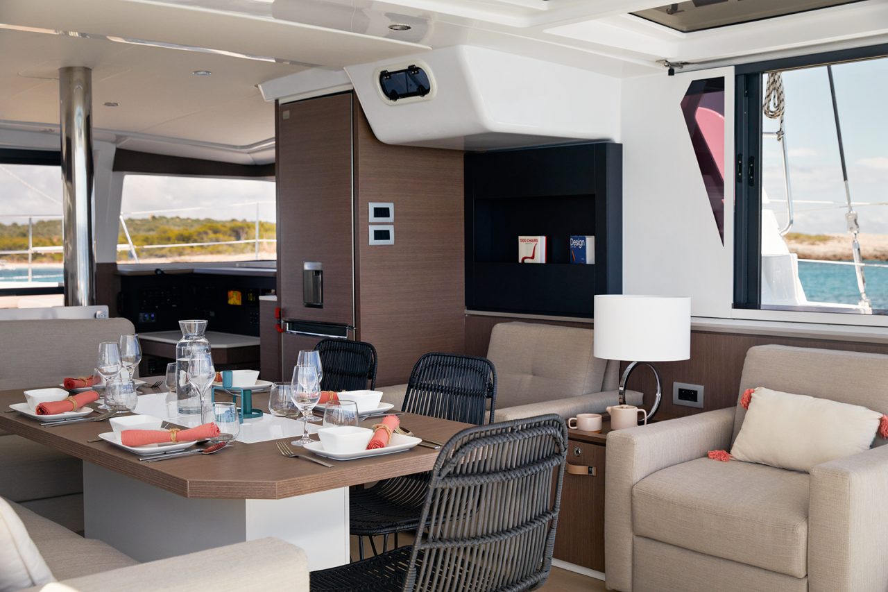 Saloon of the Bali 4.2 catamaran with dining table in foreground