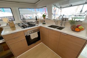 Galley kitchen with light wood finishes on the Bali 4.4 catamaran