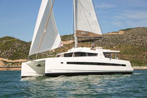 Bali 5.4 catamaran sailing on blue waters with mountain backdrop