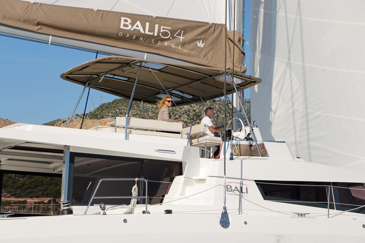 Man at the helm of a Bali 5.4 luxury sailing catamaran