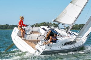 Beneteau 30.1 sailboat under sail with woman at helm