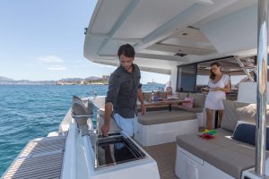 Man using the outdoor grill on the Fountaine Pajot Astrea 42 catamaran