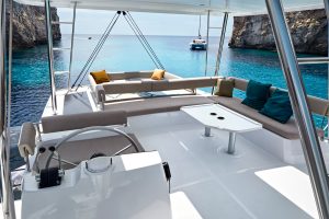 Spacious flybridge of the Bali 4.8 with helm dining area and sunbed lounge