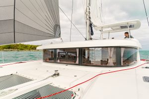 Man at the helm of the Lagoon 42 yacht