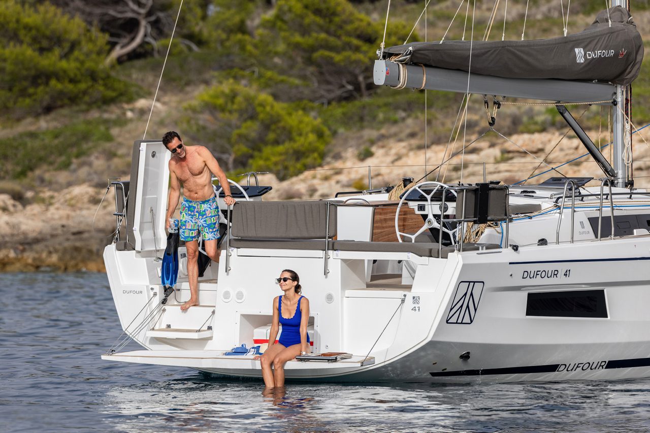 Couple on swim platform of the Dufour 41 sailing boat