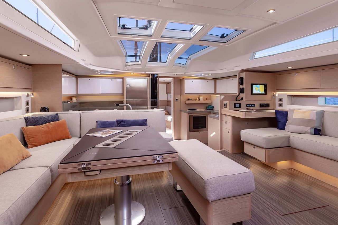 Dufour 61 monohull interior saloon dining area with large overhead skylights