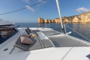 Front deck of the Elba 45 electric catamaran with lounge seating and trampoline