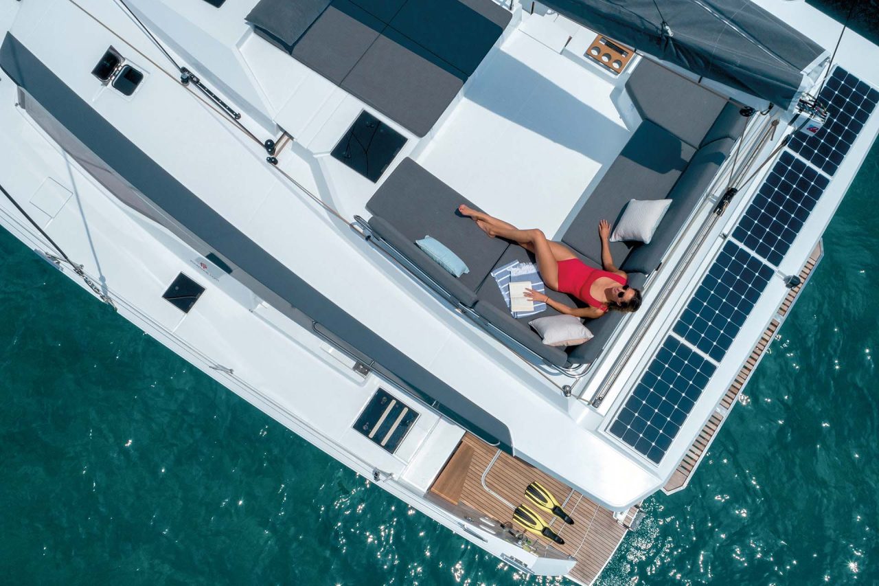 Top view of woman on flybridge lounge of the Elba 45 electric catamaran