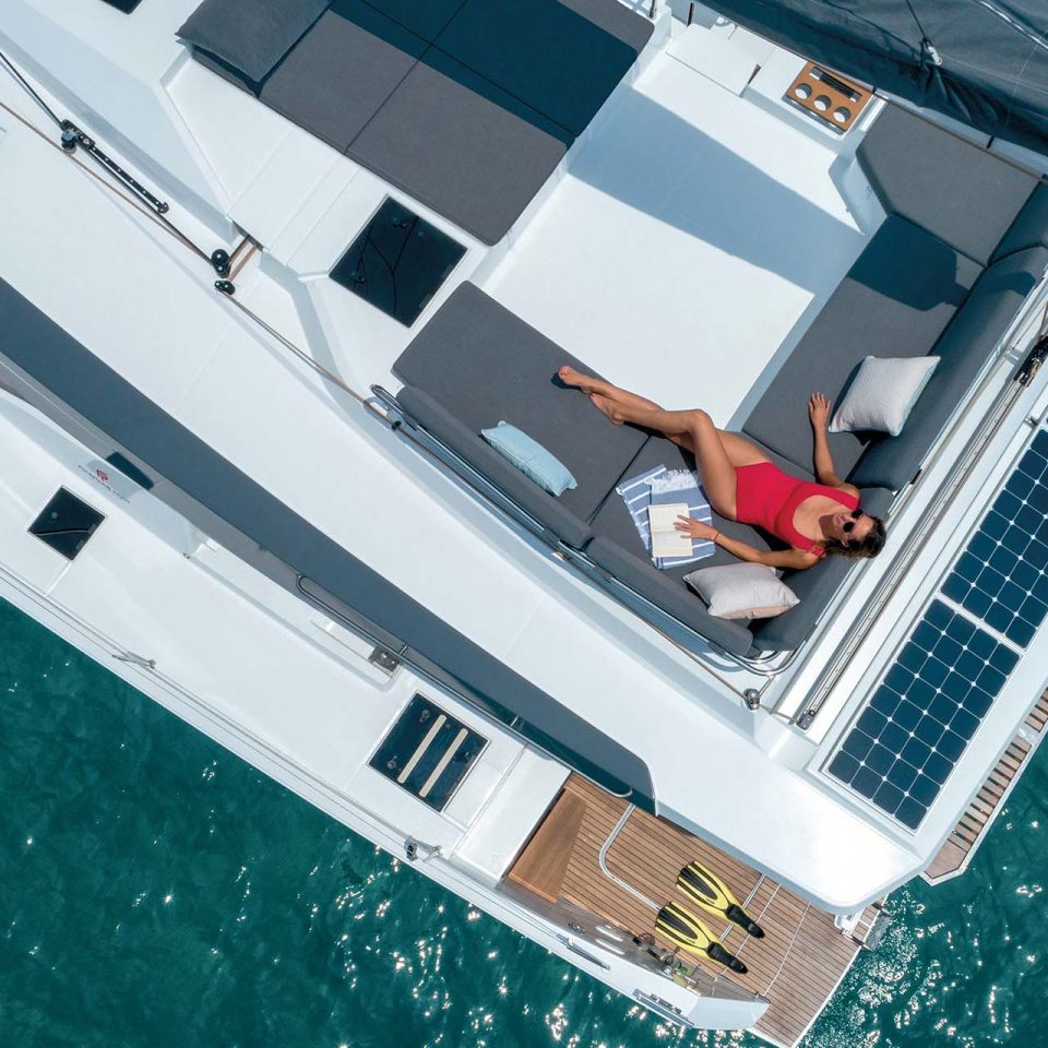 Top view of woman on flybridge lounge of the Elba 45 electric catamaran