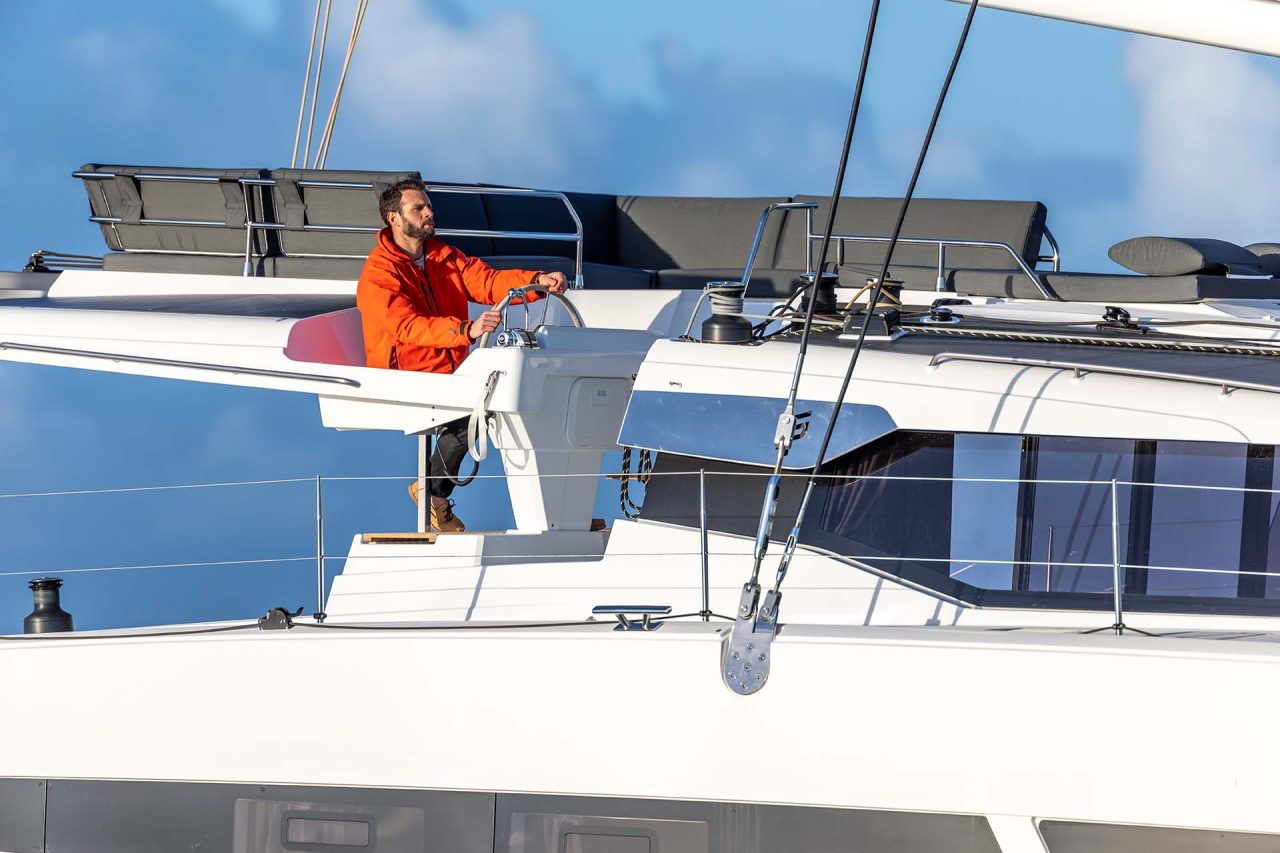 Man at helm of the Aura 51 catamaran smart electric