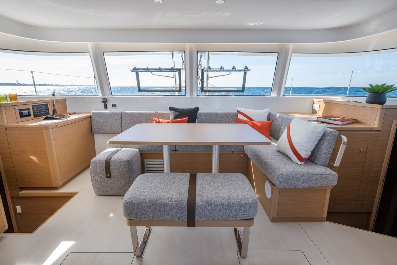 Excess 14 catamaran interior dining area with wraparound windows