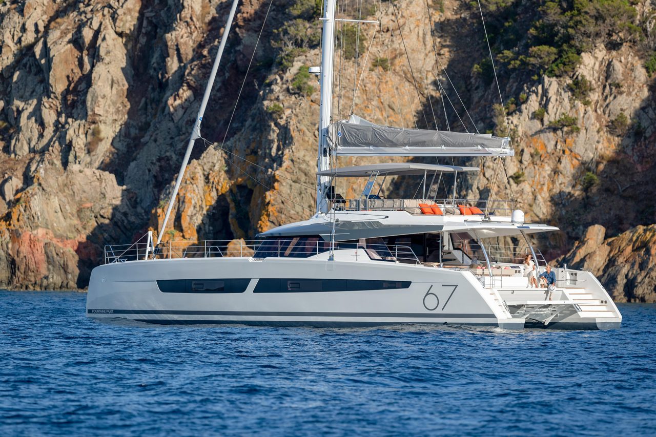 Fountaine Pajot Alegria 67 catamaran anchored near rugged coastline