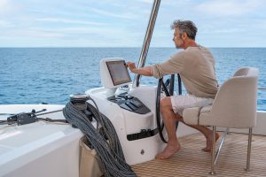 Man at the helm of the Lagoon 55 luxury catamaran