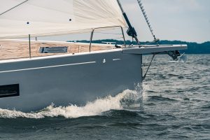 Close up of the bow of Oceanis Yacht 54 cutting through waves