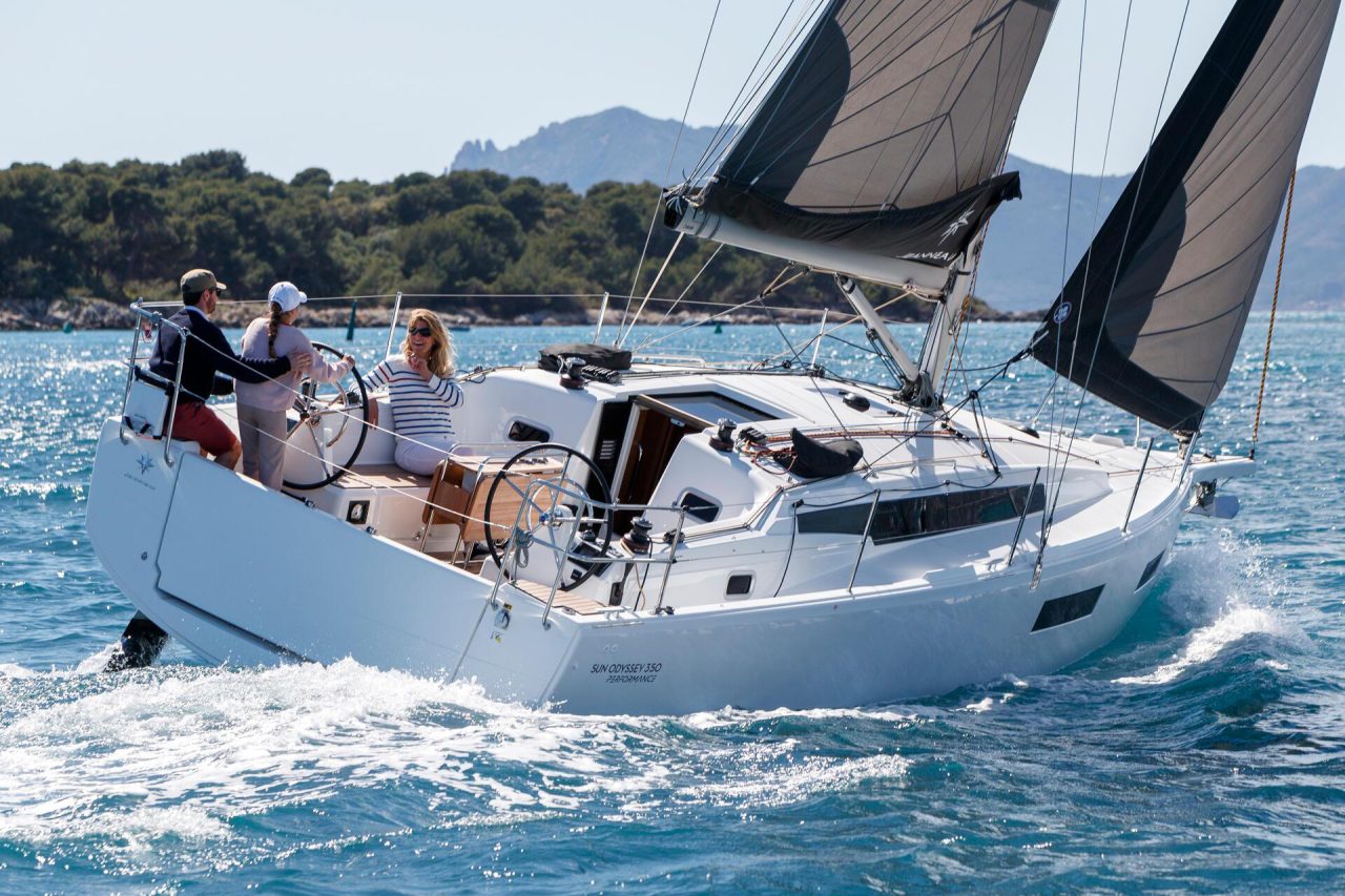 Sun Odyssey 350 sailboat at sail with people in cockpit