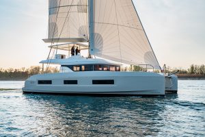 Side view of Lagoon 55 catamaran sailing at sunset