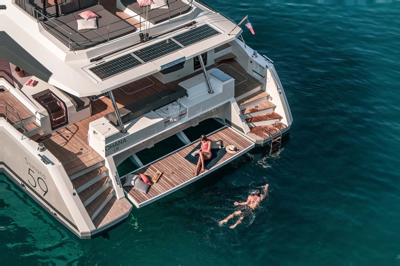 Couple enjoying the Samana 59 catamaran swim platform