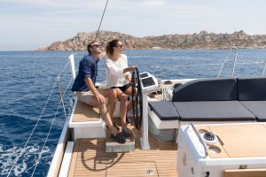 Couple at the helm sailing a Oceanis 46.1 sailing yacht